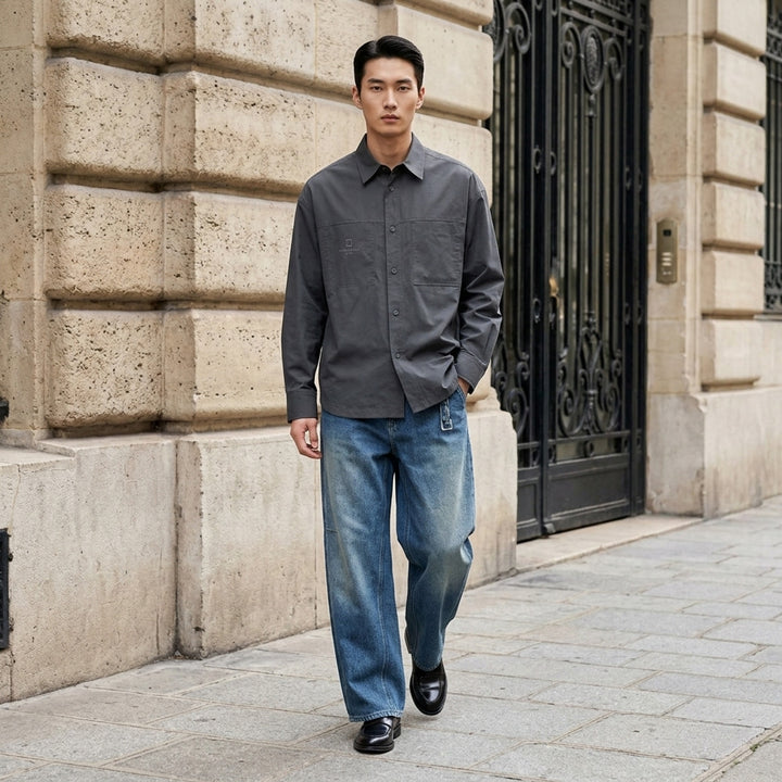 Wooyoungmi wide-leg denim pants in faded black wash with elasticated waistband and articulated knee seam detailing, front view on white background - lifestyle